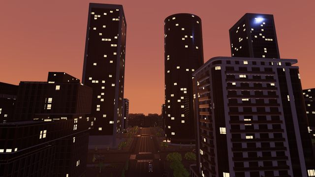 Glass towers over a downtown avenue at dusk